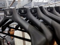 Imalay Lugo looks for the corresponding bottom for a custom suit at the Joseph Abboud manufacturing plant in New Bedford, MA.   [ PETER PEREIRA/THE STANDARD-TIMES/SCMG ]